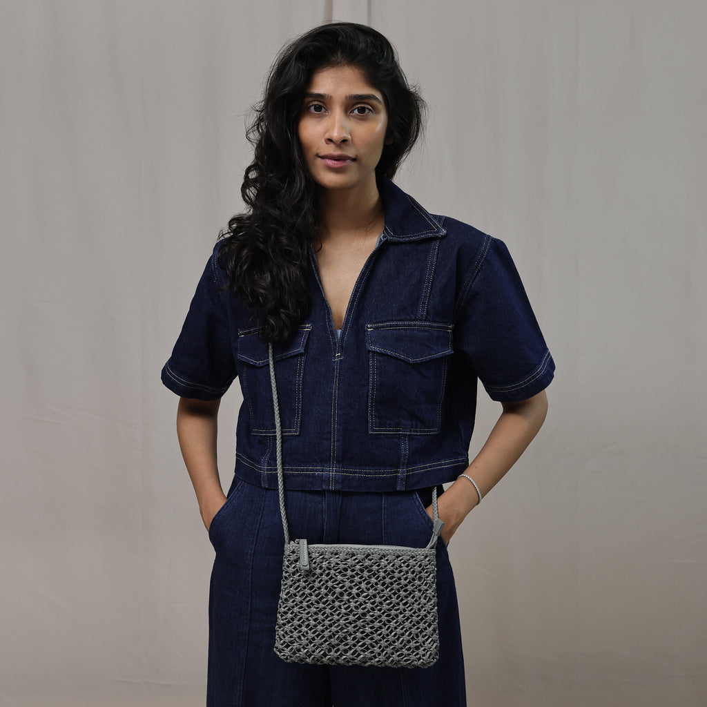 Compact grey leather crossbody bag perfect for travel and work